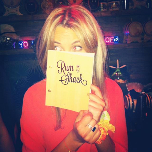 A customer with her nose into a Rum Shack menu